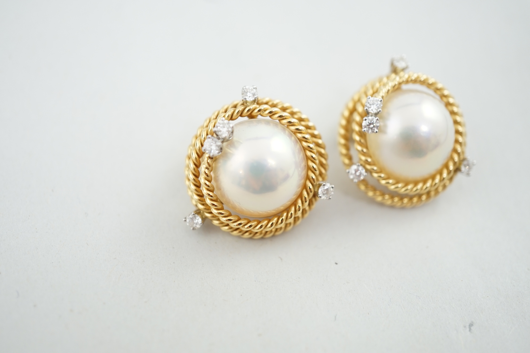 A modern pair of Tiffany & Co Schlumberger Studios 18k gold, mabe pearl and five stone diamond set ear clips